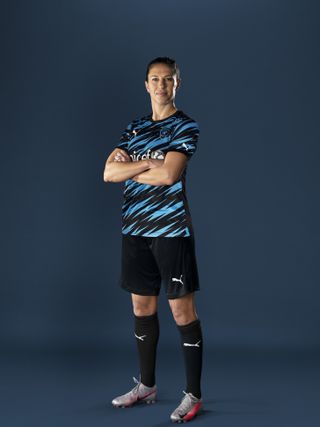 Carli Lloyd shows off her Soccer Aid kit after signing up for the event in June (Dave Kotinsky/Unicef handout)
