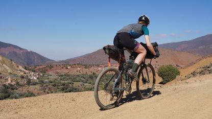 Anna Abram wearing some of the best women's gravel clothing on a bikepacking trip