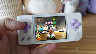 Anbernic RG28XX handheld with Crash Team Racing gameplay with race about to start