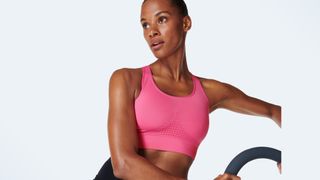 A photo of a woman wearing the Sweaty Betty Stamina Workout bra, one of the best medium-impact sports bras for women