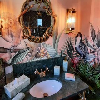 bathroom with wall mural and sink