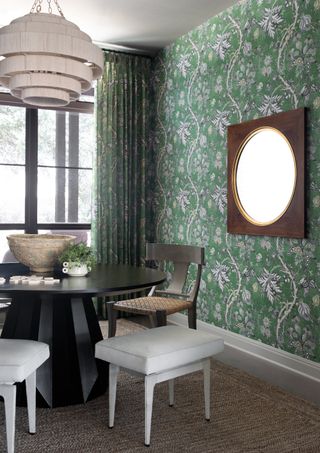 dining room with green patterned wallpaper matching the curtains