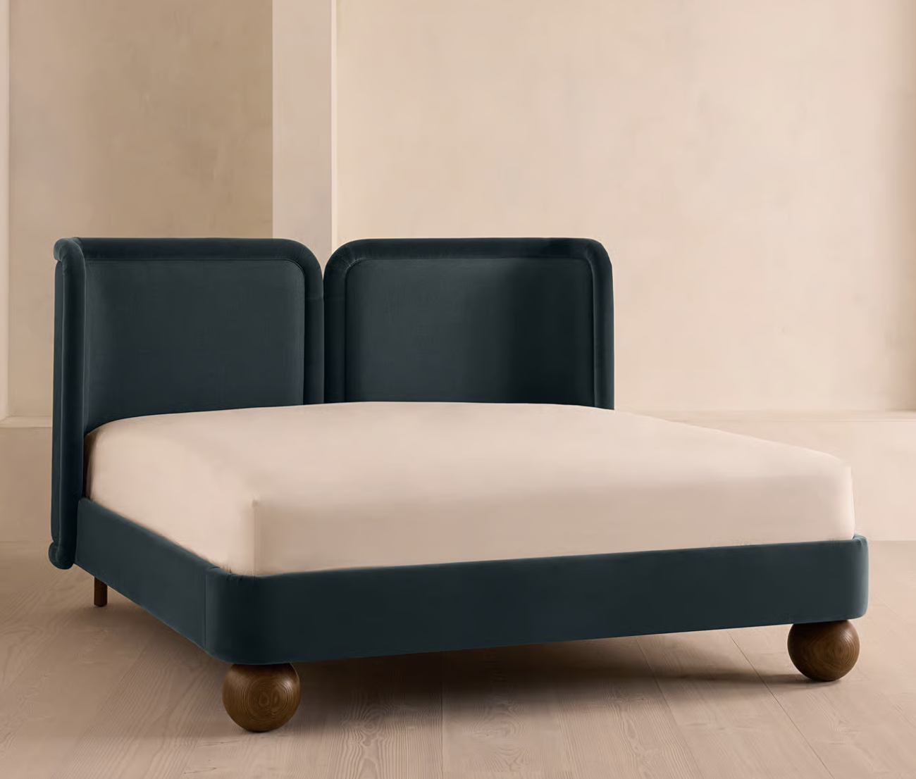 bed with blue headboard and round ball feet