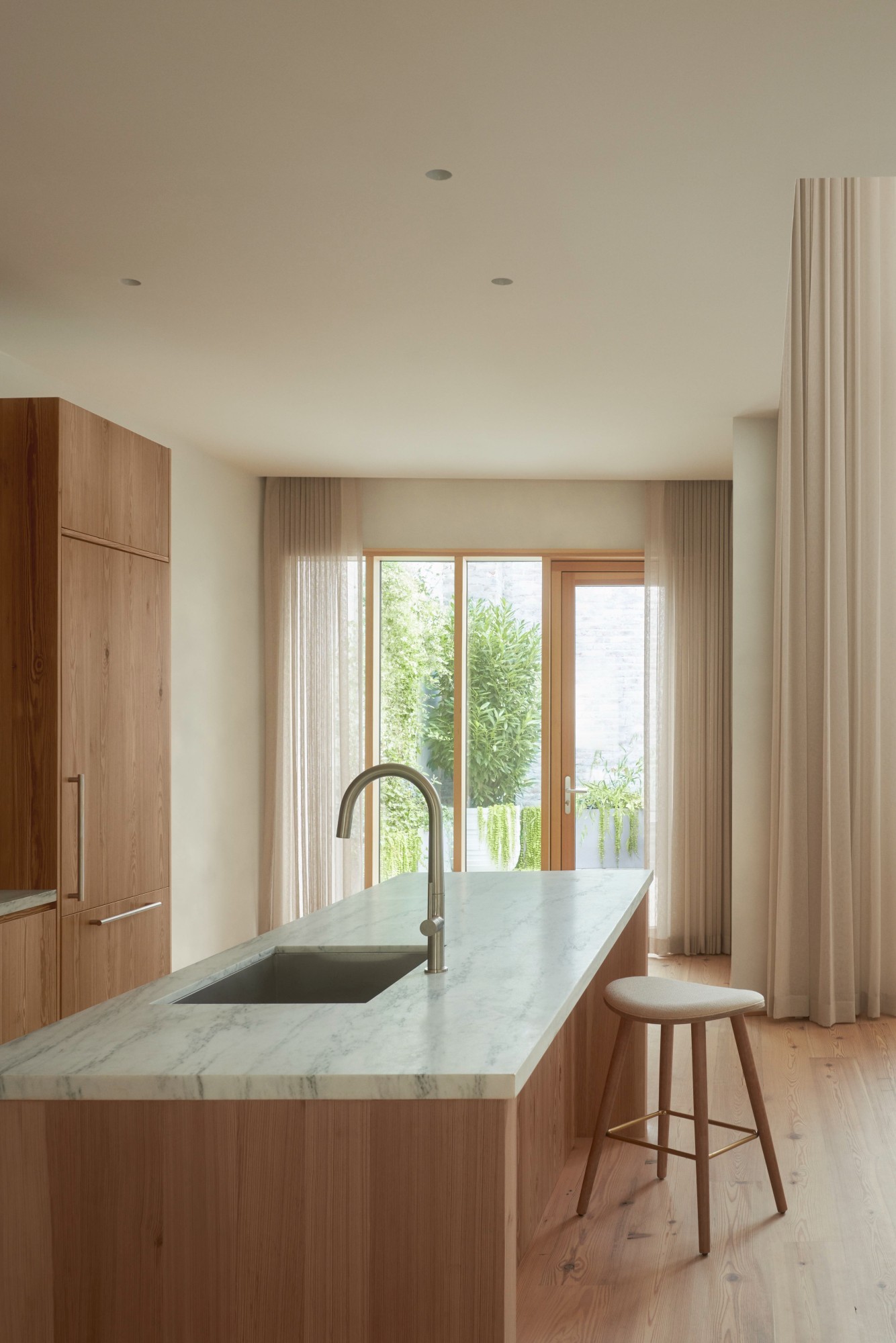 103 Grand by Of Possible, empty residential building with natural textures and high ceilings