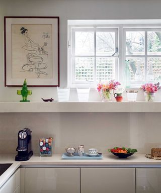 modern kitchen with window, artwork and coffee machine