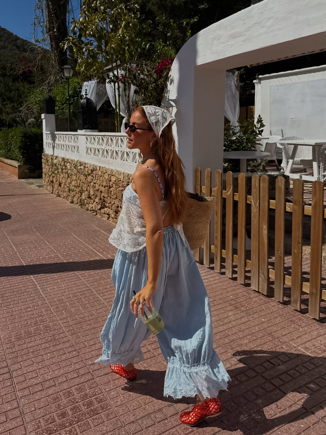 Influencer Rebecca Ferraz Wyatt wearing a bandana top, bloomers and jelly flats.