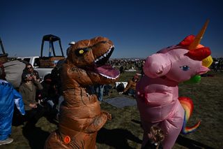 People dress in costumes as others watch the annular solar eclipse at the 51st Albuquerque International Balloon Fiesta in Albuquerque, New Mexico, on October 14, 2023.