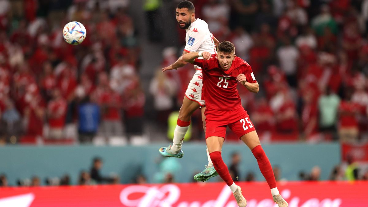 Denmark&#039;s Jesper Lindstrom heading a ball in a game against Tunisia.