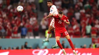Denmark's Jesper Lindstrom heading a ball in a game against Tunisia.