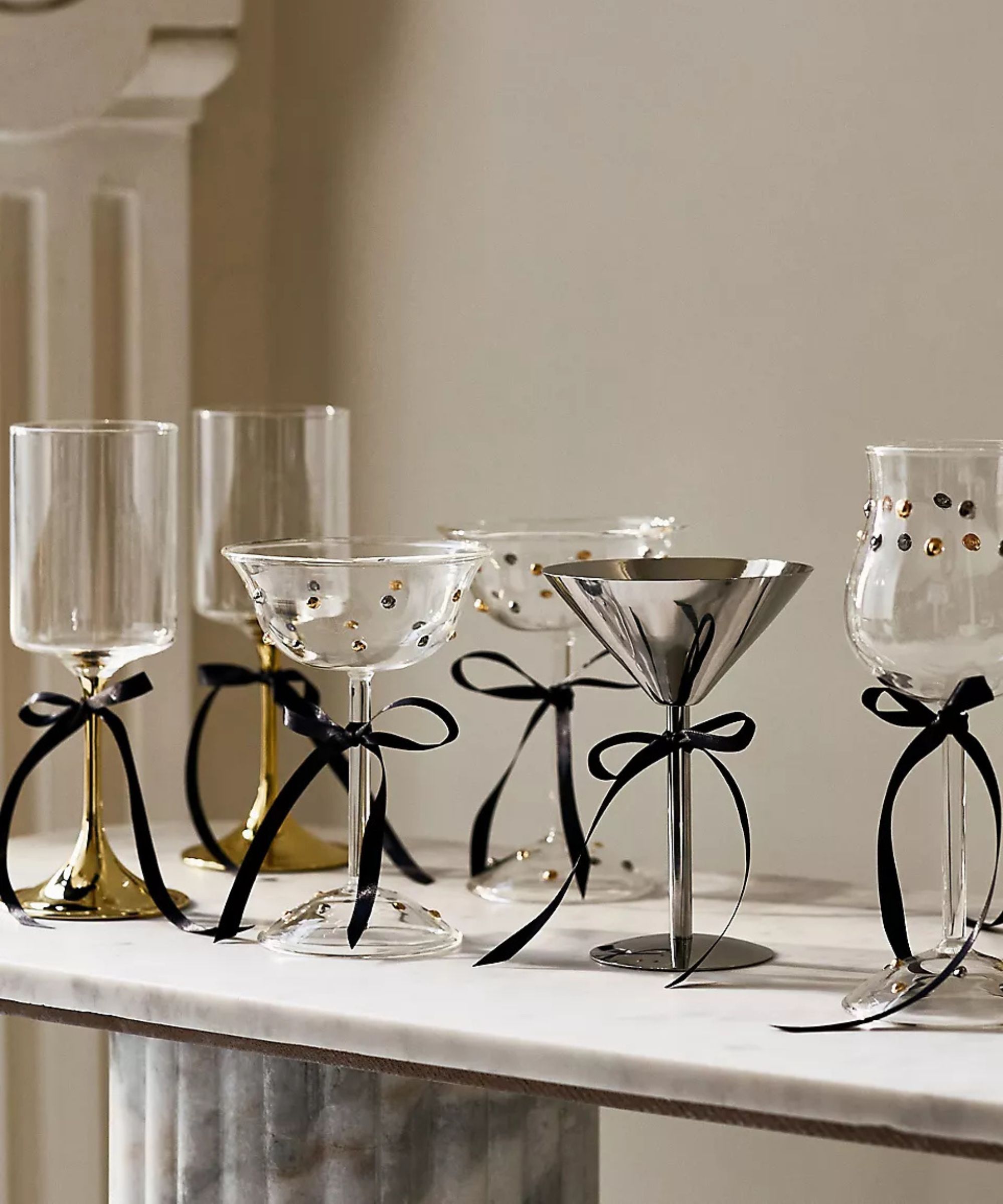 anthropologie marble table styled this varies glass flutes and coupes all tied with black ribbon