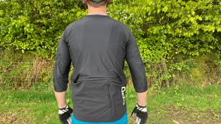 The rear of a man wearing a cycling jersey
