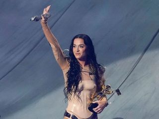 Katy Perry accepts her VMA onstage in 2024