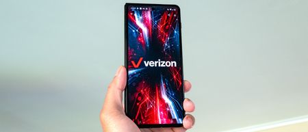 Phone held in the hand with Verizon Wireless logo on screen.