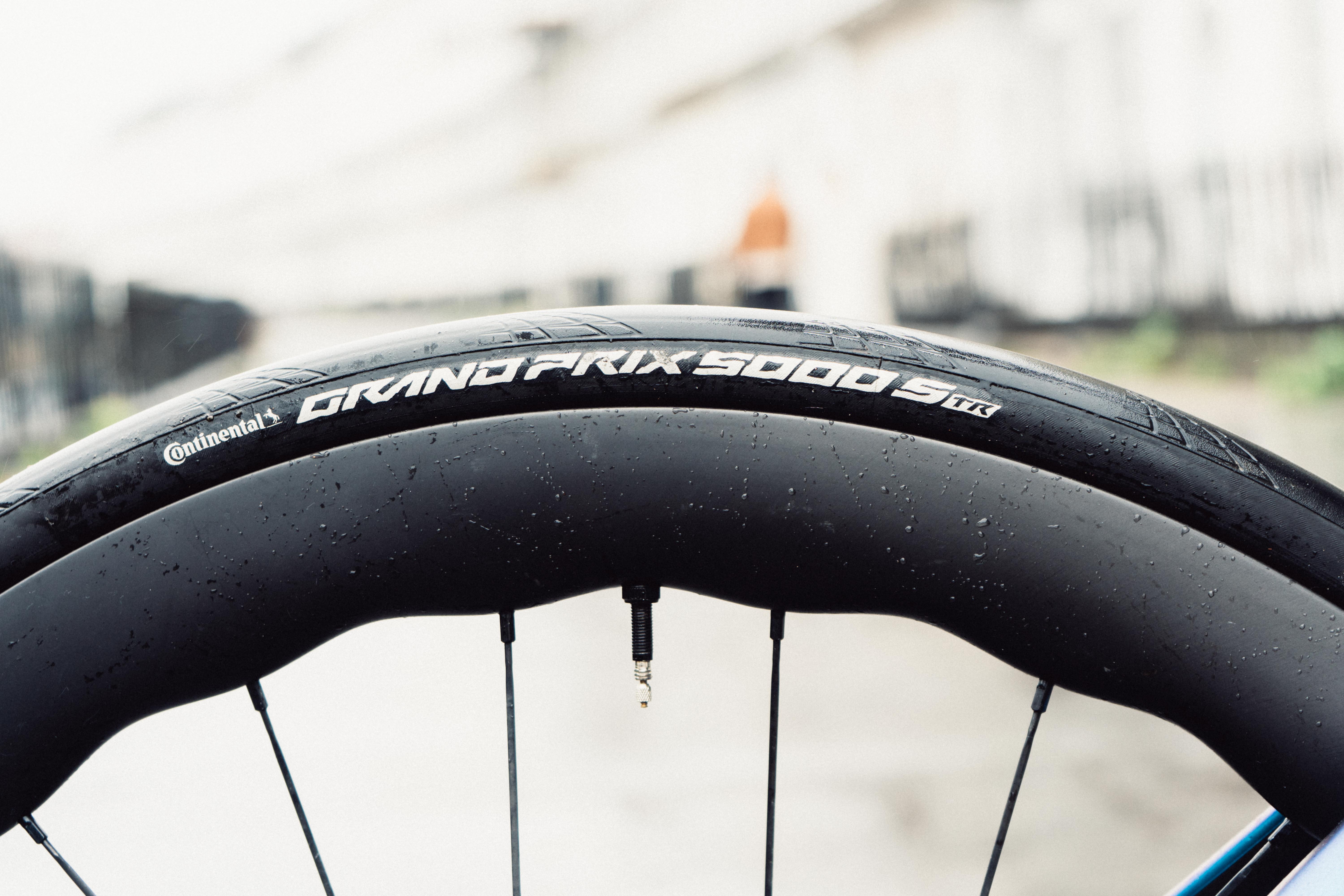 A close up of a black wavy bike wheel