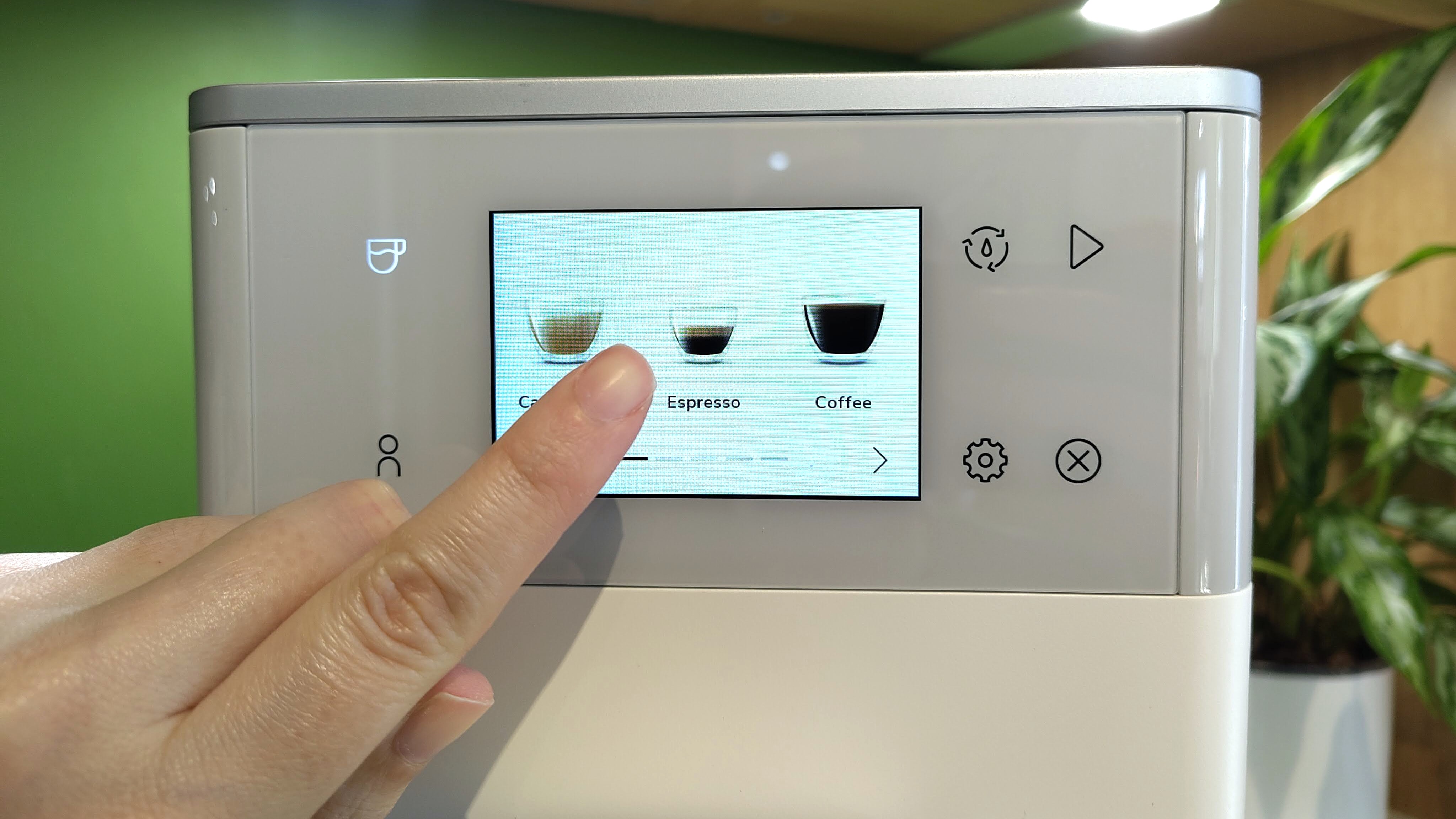 Person selecting espresso option using KitchenAid KF4 espresso machine touchscreen