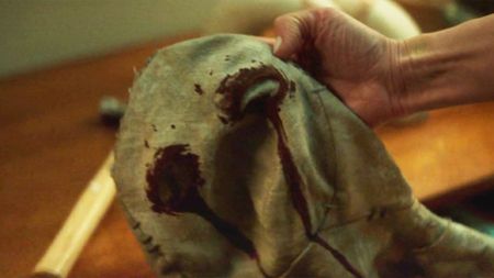 Heather Glenn's hand holding Muse's mask