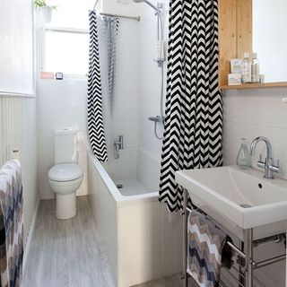 bathroom with shower tub and white tiles
