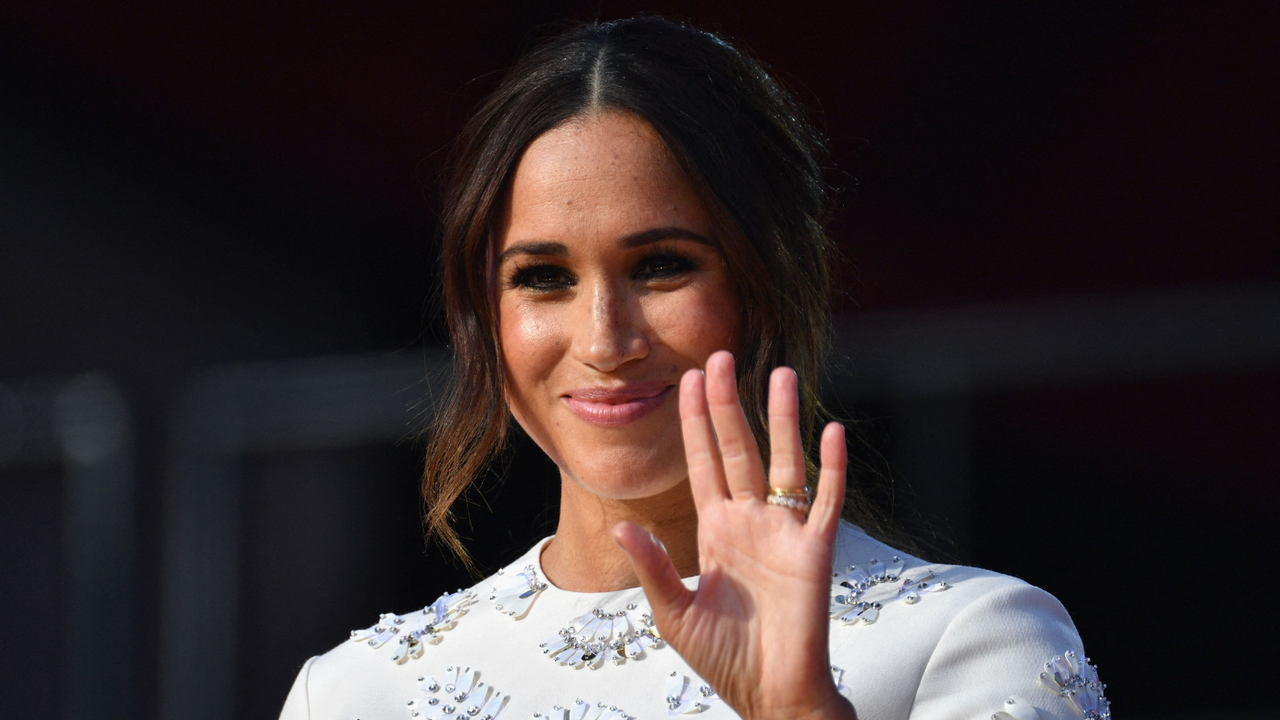 Meghan Markle waves