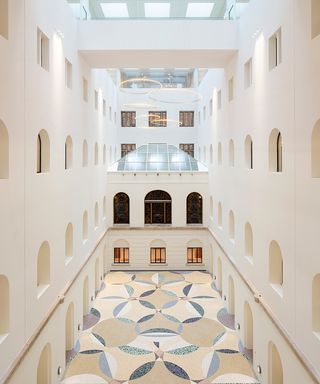 Geometric light shafts that echo the original coffered ceilings