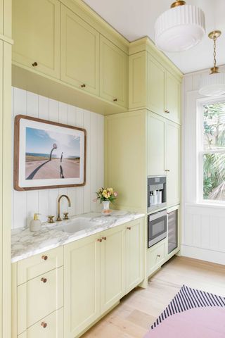 a kitchen with bright yellow cabinets