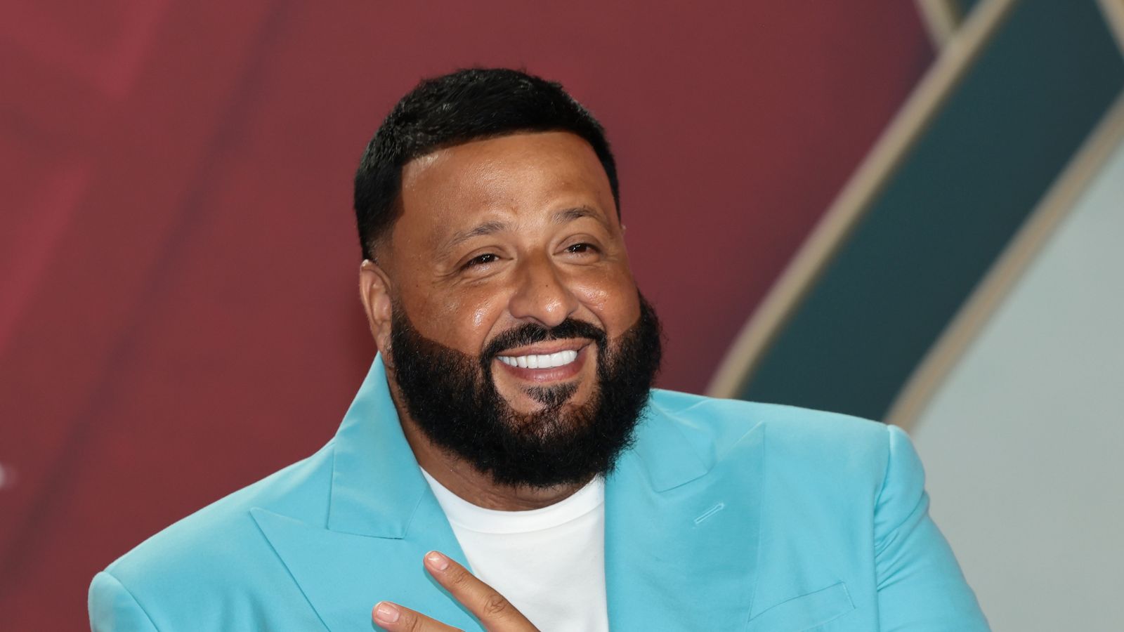 DJ Khaled on a red background