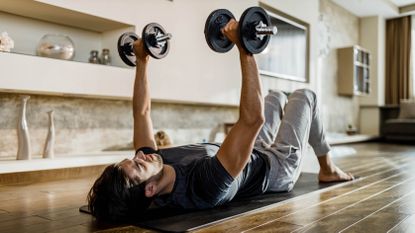 Man performing dumbbell presses