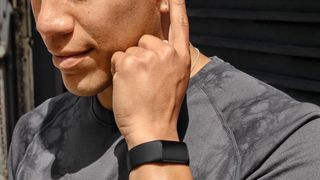 A man wears the Fitbit Charge 6 on his wrist, using it as a fitness tracker