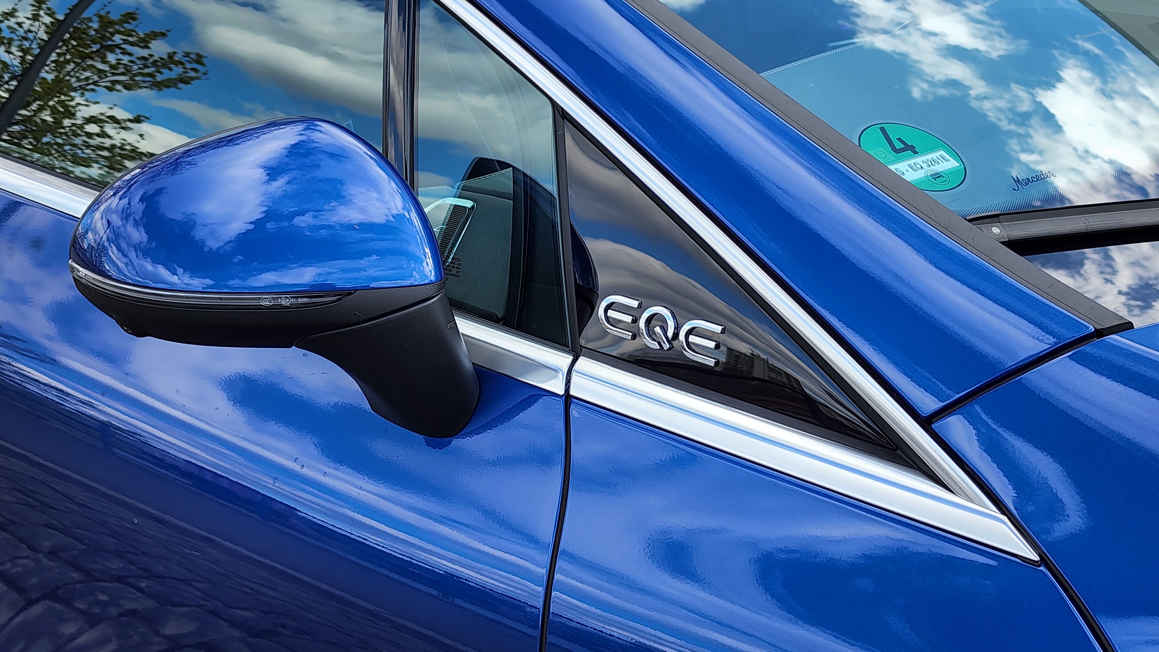 Close up of the EQE logo which is in front of the side mirror