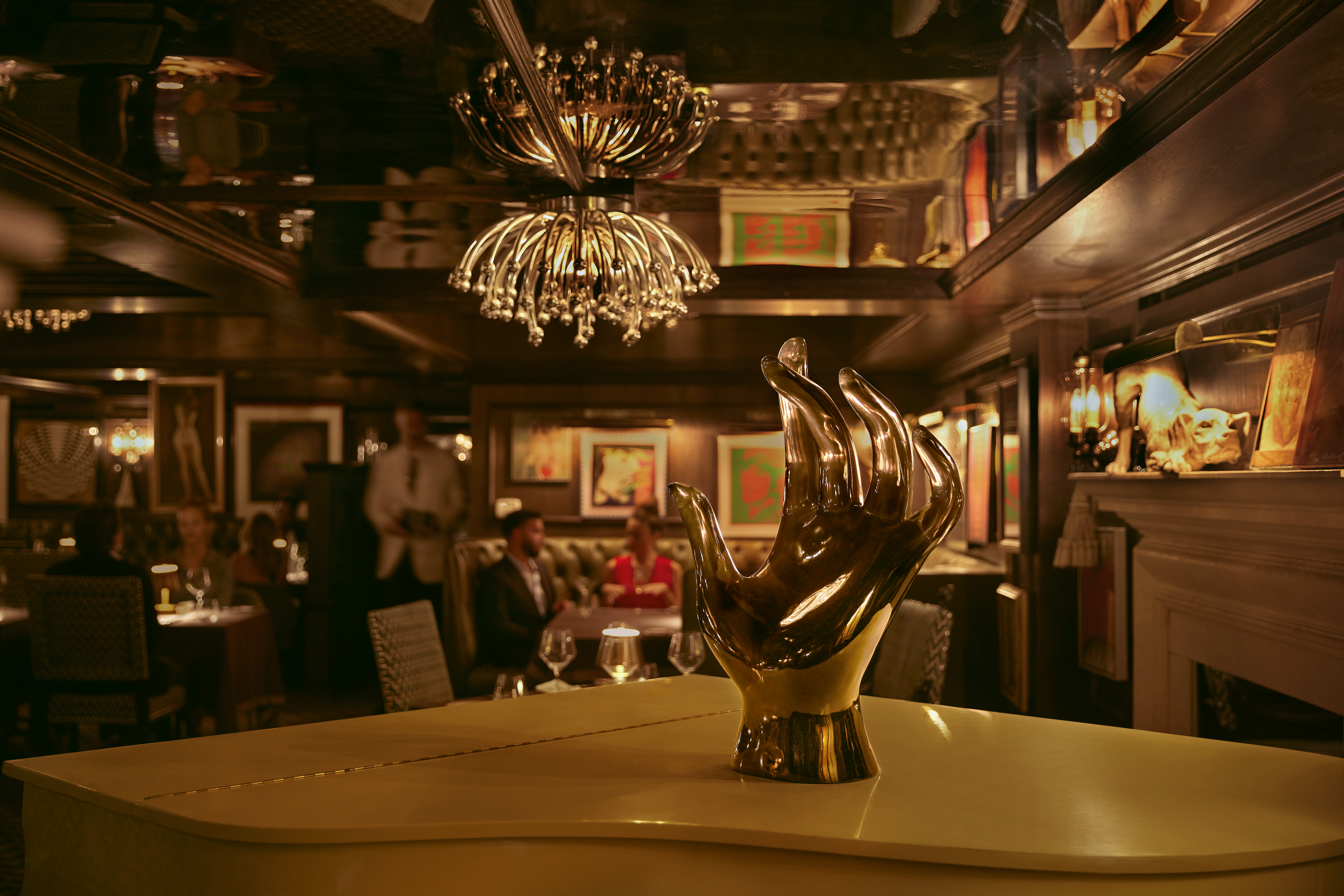 A silver hand decoration stands on top of a piano inside Mister Parker's restaurant at Parker Palm Springs