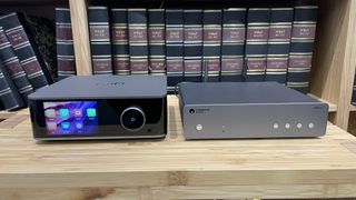 WiiM Ultra and Cambridge Audio MXN10 placed side by side on a wooden rack