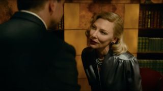 Cate Blanchett looks seductively at Bradley Cooper in Nightmare Alley.