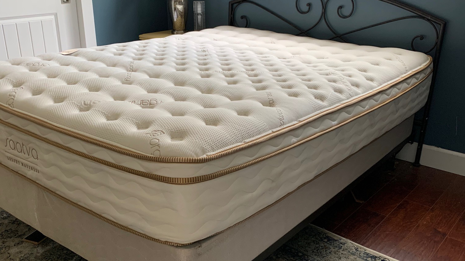 The Saatva Classic mattress shown on a black metal bed frame during testing