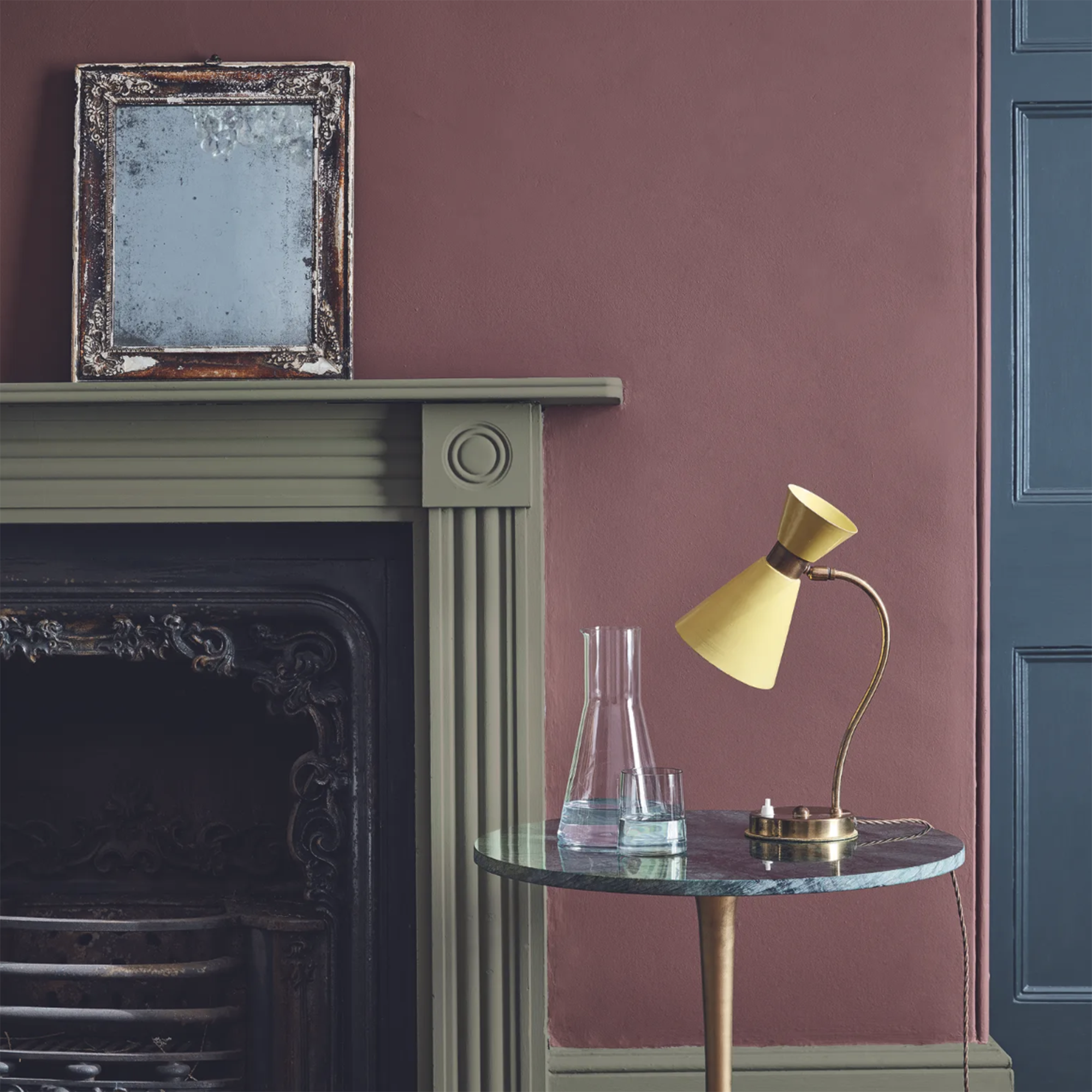 living room with dark purple wall and green fireplace