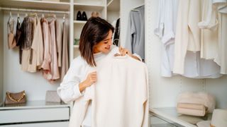 Woman sorting through her clothes