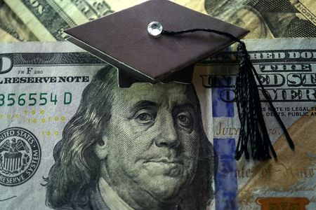 Concept art of a $100 bill with a graduation cap on the image of Ben Franklin.