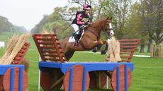 Rider jumping cross-country fence, which is one element of British Eventing XC+