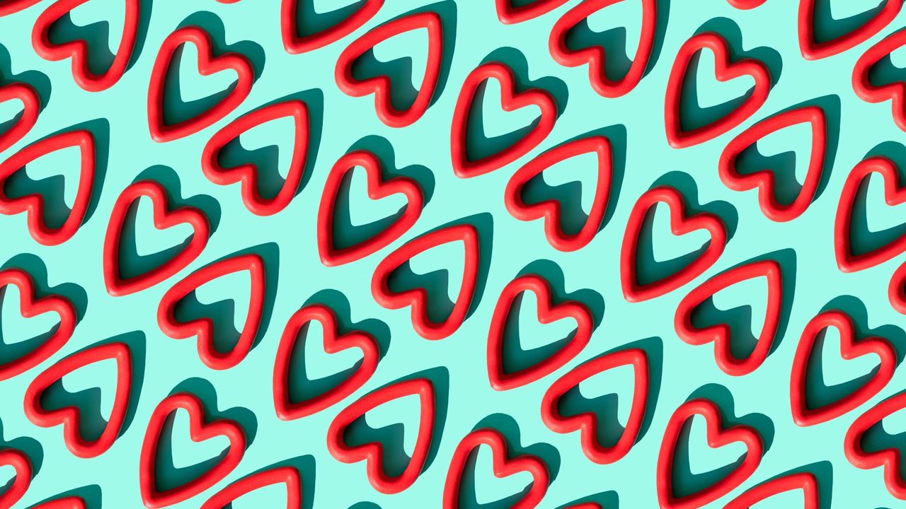 Repeated red heart shapes on the turquoise background