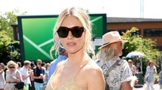 Sienna Miller at Wimbledon 2025 in a boho outfit of crochet top, white skirt and suede western belt