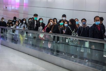 People in Hong Kong wear face masks.