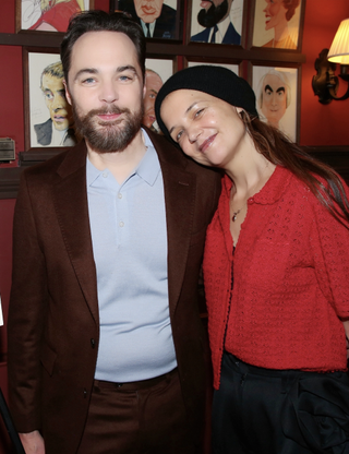 Jim Parsons and Katie Holmes pose at a celebration honoring Jim Parsons for his performance in the play "Our Town" on Broadway with a caricature on the Sardi's wall of fame at Sardi's on January 7, 2025 in New York City.