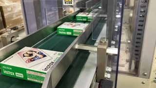 Fujifilm Instax Mini film packages emerge from an assembly line at a factory in Japan
