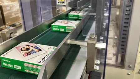 Fujifilm Instax Mini film packages emerge from an assembly line at a factory in Japan