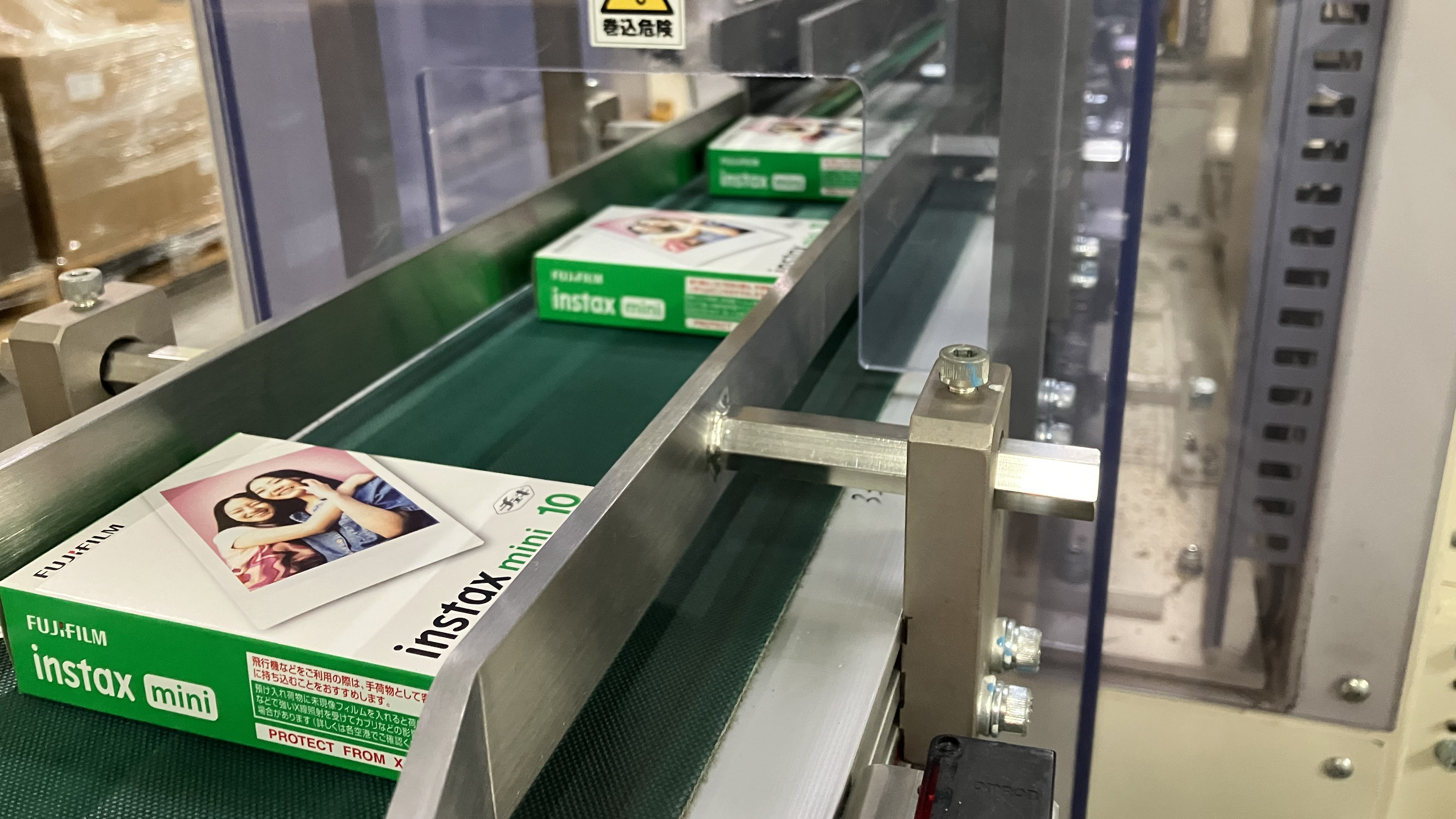 Fujifilm Instax Mini film packages emerge from an assembly line at a factory in Japan