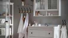 Neutral IKEA bathroom with white storage units