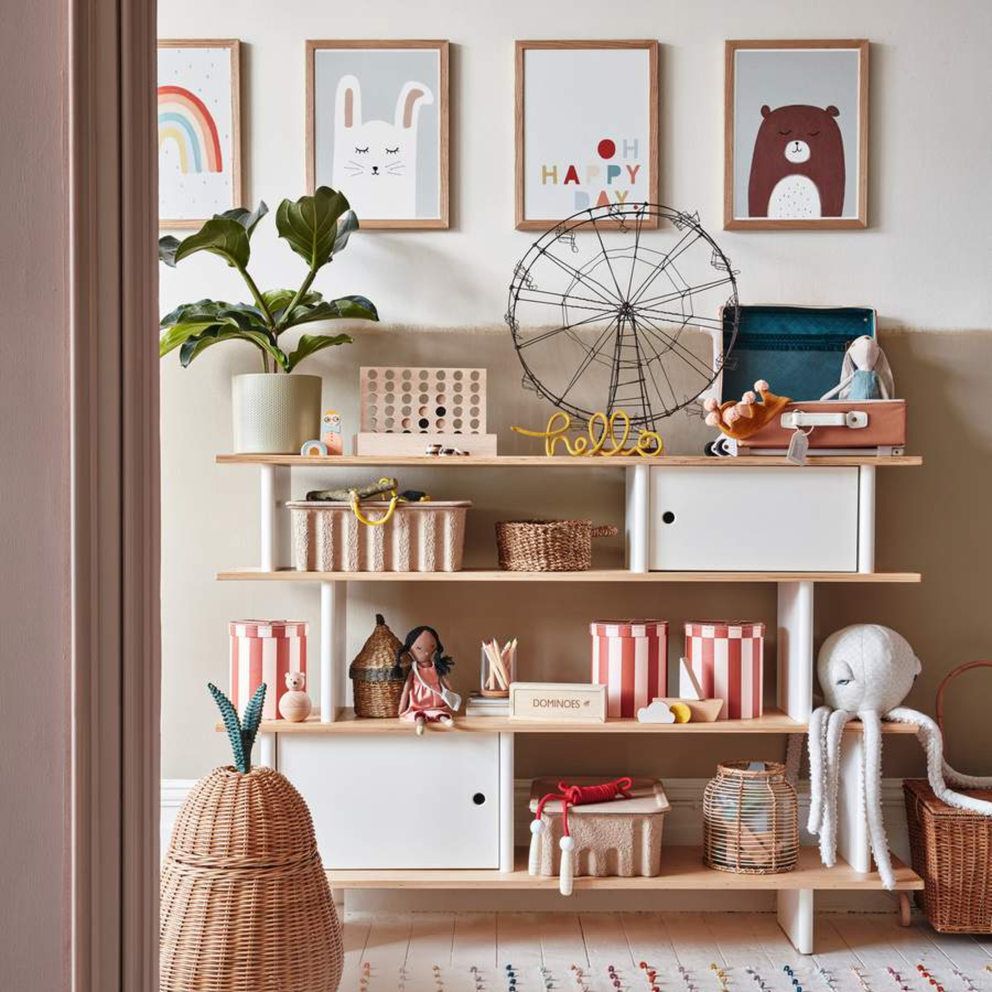 Chidrens room with shelving unit displaying assortment of home decor and hanging artwork
