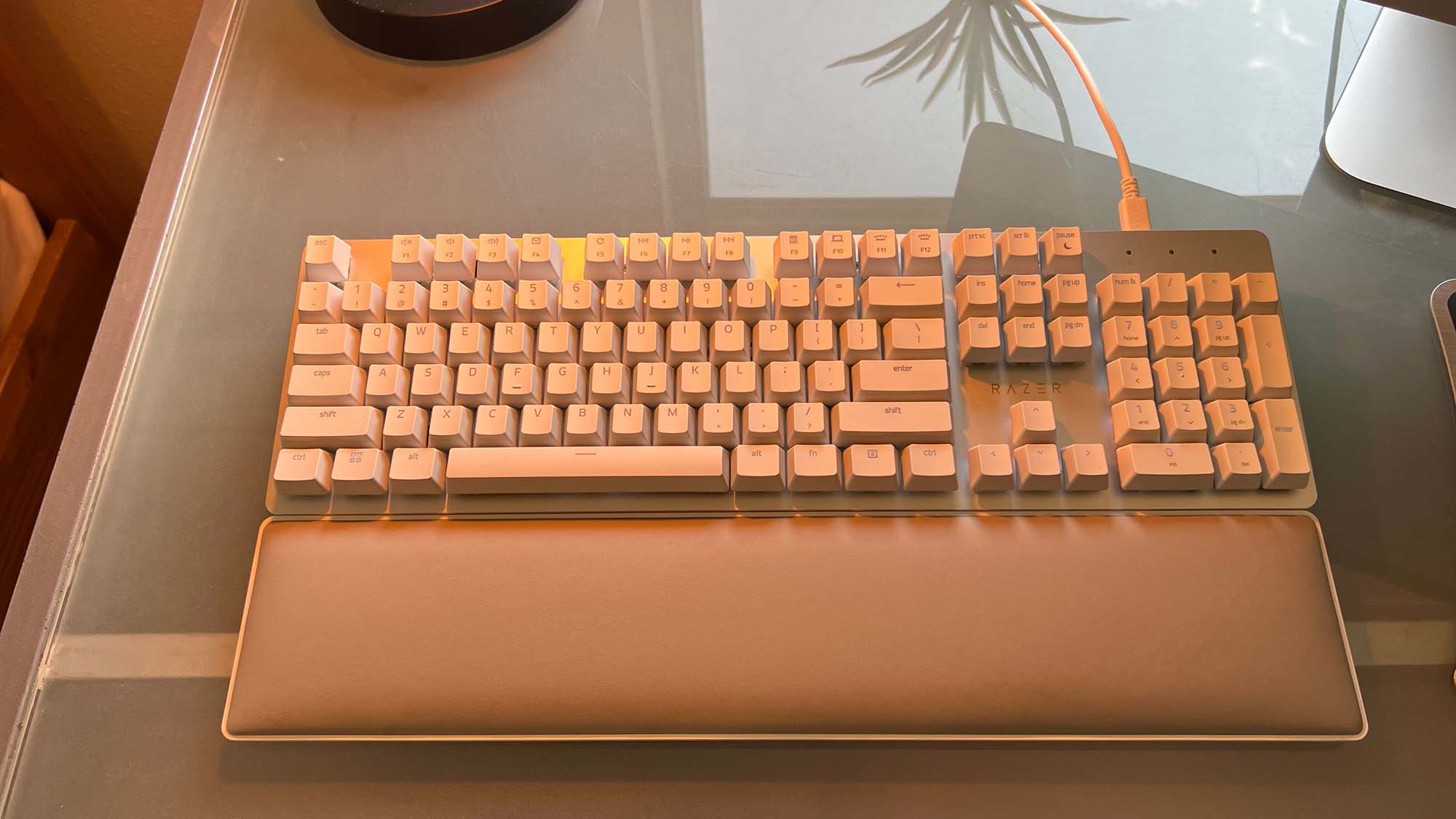 A Razer Pro Type Ultra on a glass-top desk