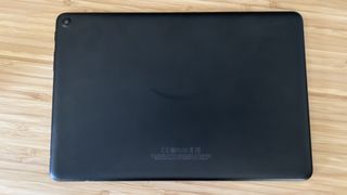 back panel of Amazon Fire HD 10 in black on a wooden table