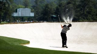 Rory McIlroy plays a fairway bunker shot during the 2011 Masters