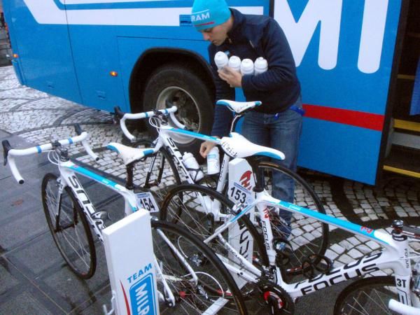 A Milram soigneur loads bidons into the riders' bikes. Odds-on many will be dislodged on the teeth-rattling pave.