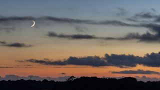 New moon on a sunset background
